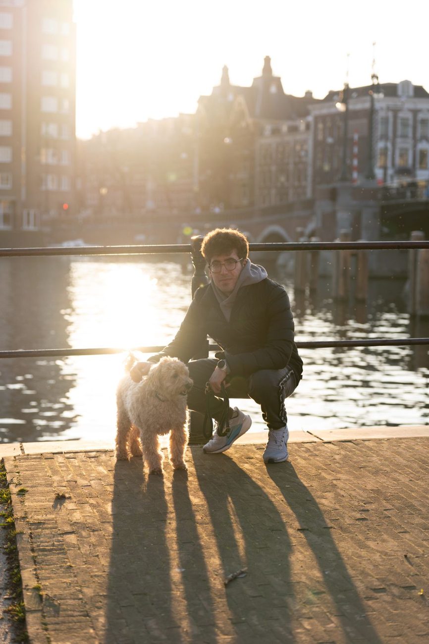 Panos and Finley the labradoodle by the water at golden hour