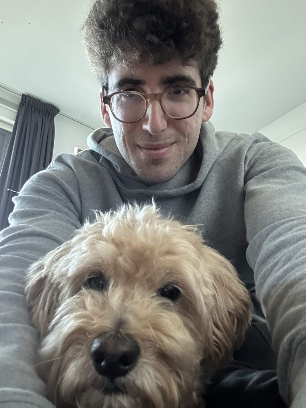 Finley the labradoodle leaning in for a selfie with Panos